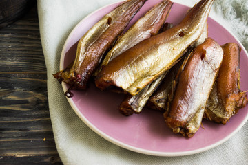Smoked fish on a wooden table in rustic style