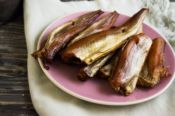 Smoked fish on a wooden table in rustic style