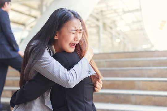 Young woman sad and crying hugging her depressed friend.Unemployment