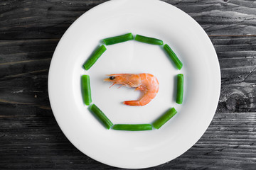Shrimps with vegetables on a wooden table in rustic style