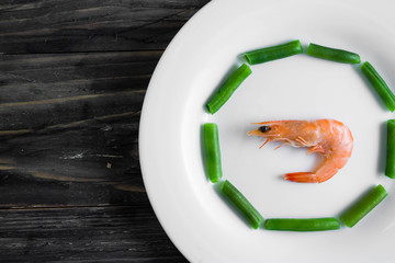 Shrimps with vegetables on a wooden table in rustic style