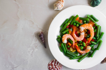 Shrimps with vegetables on a wooden table in rustic style