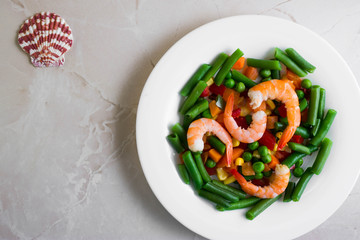 Shrimps with vegetables on a wooden table in rustic style