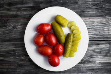 Pickled vegetables on a wooden table in rustic style