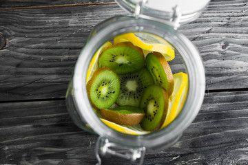 Fruits in a glass jar on a wooden table in rustic style