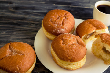 Berliner donuts on a wooden table in rustic style