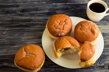 Berliner donuts on a wooden table in rustic style