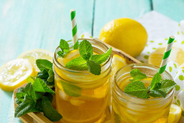 Iced tea with lemon and mint. Refreshing cold summer drink. Copy space.