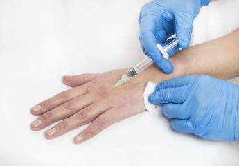 Mesotherapy process on a female hand in clinic 