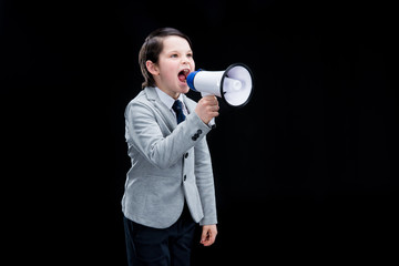 Angry Boy standing with megaphone and yelling on black