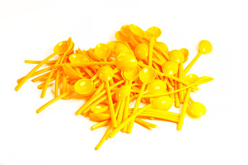 Background of many new colored plastic spoons 