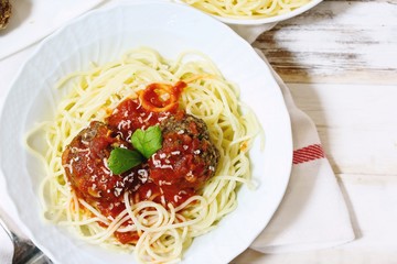 Spaghetti and Meatballs served in a white bowl, selective focus