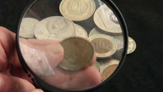 to see the collection of coins through a magnifying glass