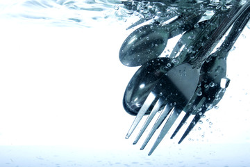 Dish washer, kitchen items in the water and bubbles