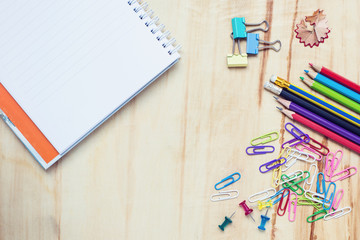 Office supplies on wood desk top shot directly above