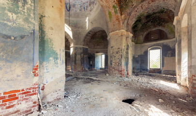 Inside an abandoned looted temple. Columns and a dome with crumbling paint and plaster
