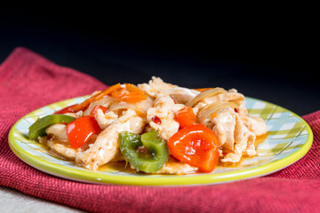 wok fried chicken stir fry with sweet peppers and chinese vegetables