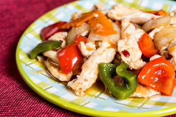 wok fried chicken stir fry with sweet peppers and chinese vegetables