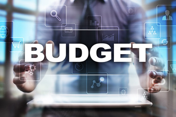 Fototapeta na wymiar Businessman using tablet pc and selecting budget.
