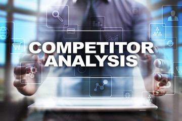 Fototapeta na wymiar Businessman using tablet pc and selecting competitor analysis.