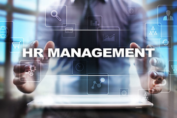 Fototapeta na wymiar Businessman using tablet pc and selecting hr management.