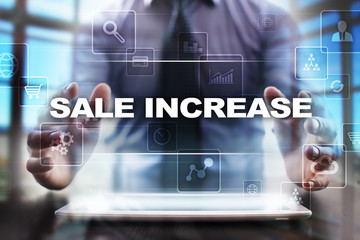 Fototapeta na wymiar Businessman using tablet pc and selecting sale increase.