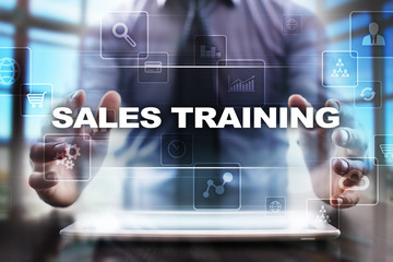 Fototapeta na wymiar Businessman using tablet pc and selecting sales training.