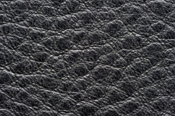 Black leather for manufacturing of shoes, clothes, bags and other fashion accessories, high quality natural seamless material sample, textured background, top view