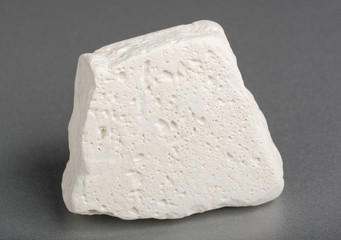 Mineral kaolinite (kaolin). The main use of  kaolinite is the production of paper.