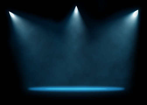 Three spotlights illuminating empty stage background.