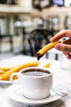 Dipping churro in hot chocolate 