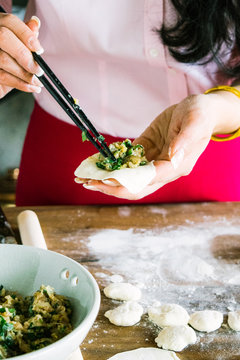Woman making Chinese dumplings 