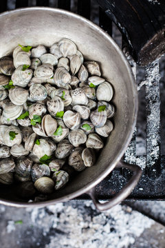 Cooking clams on charcoal burner 