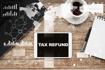 Tablet on desktop with tax refund text.