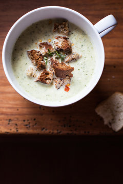 Cup of leek and potato soup with croutons 