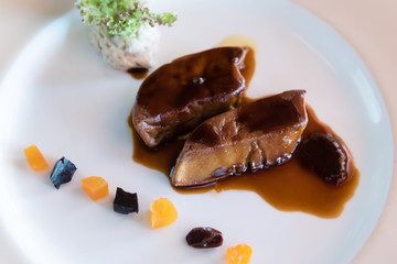 foie gras with gravy sauce on white plate served with mashed potatoes