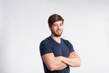 Handsome fitness man in gray t-shirt, studio shot.