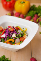 Homemade fresh green vegetable salad on table.
