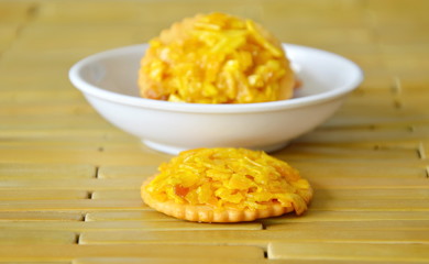 crackers topping crispy jack fruit and peanut with caramel on bamboo plate