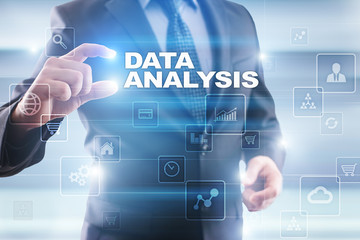 Businessman selecting data analysis on virtual screen.