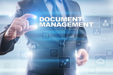 Businessman selecting document management on virtual screen.