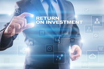 Businessman selecting return on investment on virtual screen.