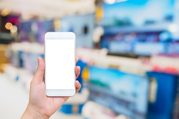 hand hold smartphone with Television shelf in eletronic department store