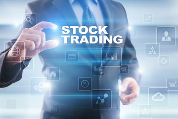 Businessman selecting stock trading on virtual screen.