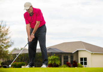 Senior man golfing