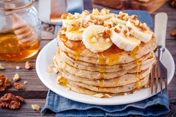 Oat pancakes with banana, walnuts and honey - obrazy, fototapety, plakaty
