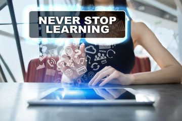 Woman using tablet pc and selecting never stop learning.