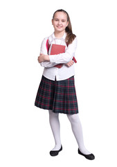 Schoolgirl in uniform stands with book and backpack isolated on white background