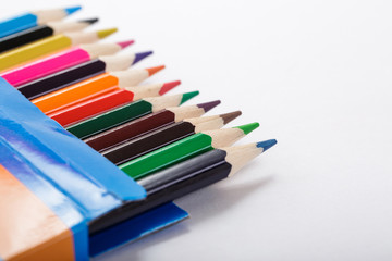 Fototapeta premium box of colored pencils and sheet of white paper