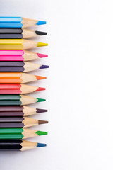 set of different colored pencils on white background